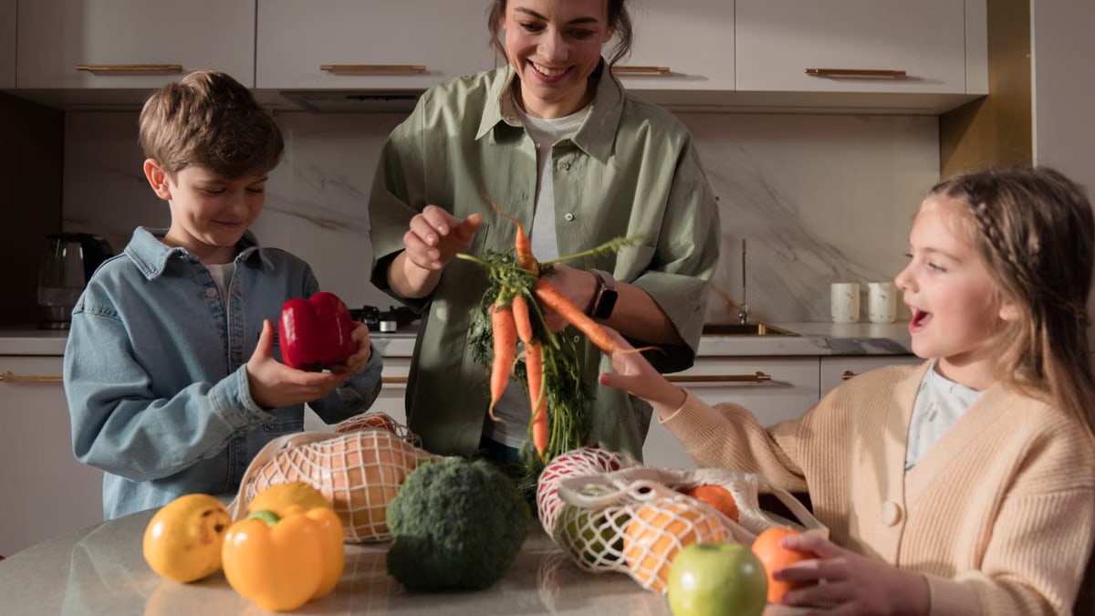 A family enjoys quality time in the kitchen, preparing a meal with fresh vegetables.